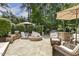 Inviting backyard patio featuring an outdoor kitchen, fire pit and comfortable seating area surrounded by lush landscaping at 5112 Highbury Grove Ln, Fuquay Varina, NC 27526