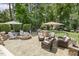 Inviting backyard patio featuring an outdoor kitchen, fire pit and comfortable seating area surrounded by lush landscaping at 5112 Highbury Grove Ln, Fuquay Varina, NC 27526