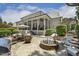 Expansive backyard patio with a fire pit, outdoor kitchen, and covered porch perfect for relaxation and entertaining at 5112 Highbury Grove Ln, Fuquay Varina, NC 27526