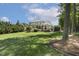 Expansive backyard with lush landscaping and a beautiful home with a covered patio at 5112 Highbury Grove Ln, Fuquay Varina, NC 27526