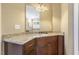 Bathroom vanity with granite counters, dark wood cabinets, and a large mirror at 5112 Highbury Grove Ln, Fuquay Varina, NC 27526