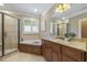The primary bathroom features a glass-enclosed shower, tub, and double vanity at 5112 Highbury Grove Ln, Fuquay Varina, NC 27526