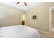 Neutral bedroom with a doorway to a bathroom and a view of the ceiling fan at 5112 Highbury Grove Ln, Fuquay Varina, NC 27526