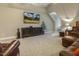 Cozy bonus room featuring leather seating, large media screen, and neutral carpeting, perfect for relaxing and entertaining at 5112 Highbury Grove Ln, Fuquay Varina, NC 27526