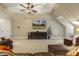 Spacious bonus room featuring leather seating, large media screen, and neutral carpeting, perfect for relaxing and entertaining at 5112 Highbury Grove Ln, Fuquay Varina, NC 27526