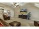 Inviting bonus room with a sofa, media screen, built-in shelving, and neutral carpeting, perfect for relaxing and entertaining at 5112 Highbury Grove Ln, Fuquay Varina, NC 27526