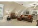 Inviting bonus room with leather seating, wet bar, and neutral carpeting, perfect for relaxing and entertaining at 5112 Highbury Grove Ln, Fuquay Varina, NC 27526