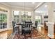 Inviting dining room featuring bright natural light, dark wood table, and access to outdoor space at 5112 Highbury Grove Ln, Fuquay Varina, NC 27526