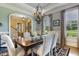 Inviting dining room featuring a chandelier, large windows, and open layout at 5112 Highbury Grove Ln, Fuquay Varina, NC 27526