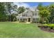 Elegant two-story home boasting a lush green lawn, classic brick facade, and well-manicured landscaping at 5112 Highbury Grove Ln, Fuquay Varina, NC 27526