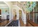 Inviting foyer features hardwood floors, staircase, decorative wreath, and views into other rooms at 5112 Highbury Grove Ln, Fuquay Varina, NC 27526