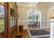 Welcoming foyer featuring a hardwood floor, staircase, view of the dining room, and a stylish wood door at 5112 Highbury Grove Ln, Fuquay Varina, NC 27526