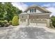 Spacious three-car garage with well-maintained doors, showcasing ample parking at 5112 Highbury Grove Ln, Fuquay Varina, NC 27526