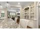 View of the kitchen with granite counters, seating, and adjacent living area at 5112 Highbury Grove Ln, Fuquay Varina, NC 27526