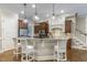 Gourmet kitchen boasts granite countertops, stainless appliances, and stylish pendant lighting at 5112 Highbury Grove Ln, Fuquay Varina, NC 27526
