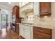 Well-equipped kitchen with granite countertops, tiled backsplash, and custom cabinetry at 5112 Highbury Grove Ln, Fuquay Varina, NC 27526