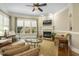 Inviting living room with fireplace, large windows, and comfortable seating area at 5112 Highbury Grove Ln, Fuquay Varina, NC 27526
