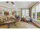 Bright living space featuring large windows, hardwood floors, and comfortable seating arrangement at 5112 Highbury Grove Ln, Fuquay Varina, NC 27526