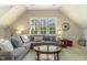 Bright living room features vaulted ceilings, lots of light and large sectional couch at 5112 Highbury Grove Ln, Fuquay Varina, NC 27526