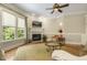 Bright living room features a fireplace, large windows, and neutral color palette at 5112 Highbury Grove Ln, Fuquay Varina, NC 27526