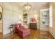 Cozy living room with hardwood floors, built-in bookshelves, elegant lighting, and comfortable seating at 5112 Highbury Grove Ln, Fuquay Varina, NC 27526
