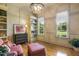 Comfortable sitting area with hardwood floors, custom built-ins, natural light, and stylish decor at 5112 Highbury Grove Ln, Fuquay Varina, NC 27526