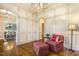 Comfortable living room featuring a pink armchair, ottoman, and stylish decor at 5112 Highbury Grove Ln, Fuquay Varina, NC 27526