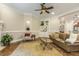 Cozy living room featuring hardwood floors, a ceiling fan, and built-in shelving for decor and storage at 5112 Highbury Grove Ln, Fuquay Varina, NC 27526