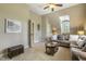 Cozy living room with a comfortable sofa and large window and door to bath, perfect for relaxing and enjoying the view at 5112 Highbury Grove Ln, Fuquay Varina, NC 27526