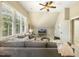 Spacious living room featuring a large sectional sofa, and natural light from large windows at 5112 Highbury Grove Ln, Fuquay Varina, NC 27526