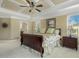 Main bedroom showcasing trey ceilings, windows, a ceiling fan, and neutral tones at 5112 Highbury Grove Ln, Fuquay Varina, NC 27526