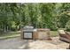 Stone outdoor kitchen has stainless steel appliances perfect for entertaining at 5112 Highbury Grove Ln, Fuquay Varina, NC 27526