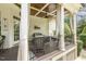 Relaxing porch area with comfortable wicker seating, perfect for enjoying the outdoor ambiance at 5112 Highbury Grove Ln, Fuquay Varina, NC 27526