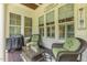 Charming outdoor porch featuring cozy wicker seating, a grill, and decorative accents at 5112 Highbury Grove Ln, Fuquay Varina, NC 27526