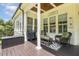 Welcoming back porch area with comfortable wicker seating, perfect for outdoor relaxation at 5112 Highbury Grove Ln, Fuquay Varina, NC 27526