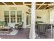 Inviting porch with wicker furniture, offering a comfortable and stylish outdoor living space at 5112 Highbury Grove Ln, Fuquay Varina, NC 27526