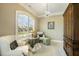 Sitting room with a large arched window, a chandelier, and two white armchairs at 5112 Highbury Grove Ln, Fuquay Varina, NC 27526