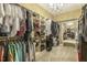 Spacious walk-in closet featuring custom shelving and a stylish chandelier at 5112 Highbury Grove Ln, Fuquay Varina, NC 27526