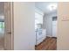 Updated kitchen with white appliances, white cabinets, and view of outdoor balcony at 514 Pine Ridge Pl, Raleigh, NC 27609