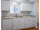 Updated kitchen with white cabinets, granite countertops and a white dishwasher at 514 Pine Ridge Pl, Raleigh, NC 27609