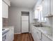 Updated kitchen with white cabinets, granite countertops, and stainless steel sink at 514 Pine Ridge Pl, Raleigh, NC 27609