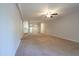 A spacious living room showcasing neutral carpet, ceiling fan and view into kitchen area at 514 Pine Ridge Pl, Raleigh, NC 27609