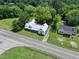 Aerial view of the property showcasing the home, lush greenery, and nearby road access at 522 Providence Rd, Roxboro, NC 27573