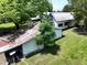 Backyard featuring the home, mature trees, and several storage sheds at 522 Providence Rd, Roxboro, NC 27573