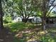 View of the home surrounded by mature trees and lush greenery at 522 Providence Rd, Roxboro, NC 27573