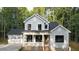 Charming two-story home with a covered porch and attached two car garage at 5491 Silk Hope Gum Springs Rd, Siler City, NC 27344
