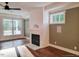 Cozy living room featuring a fireplace with herringbone tile and hardwood floors at 5491 Silk Hope Gum Springs Rd, Siler City, NC 27344