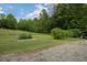 Green backyard with raised garden bed and an outbuilding, offering a peaceful setting at 578 Jeffries Cross Rd, Burlington, NC 27217