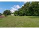 Well-maintained backyard with a shed, surrounded by mature trees, perfect for outdoor activities at 578 Jeffries Cross Rd, Burlington, NC 27217