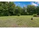 Expansive backyard featuring lush green grass and mature trees, creating a serene and private outdoor space at 578 Jeffries Cross Rd, Burlington, NC 27217